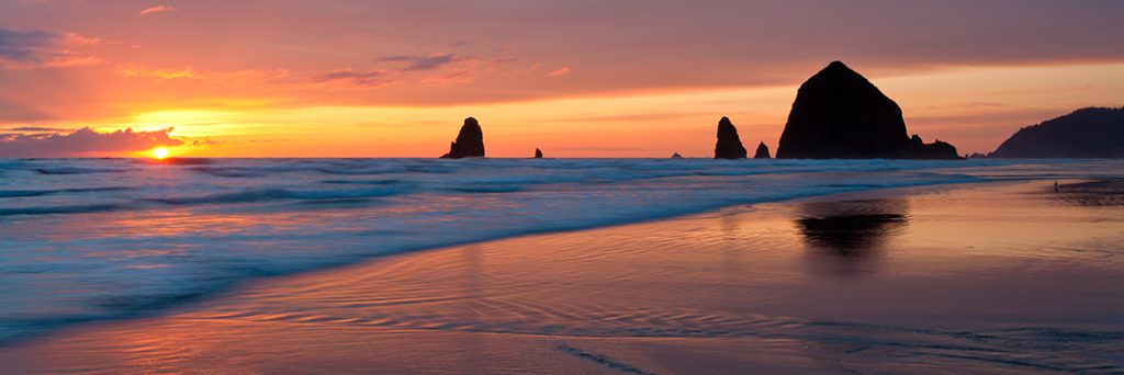 Panoramic photo of Haystack Rock, Cannon Beach, Oregon.
