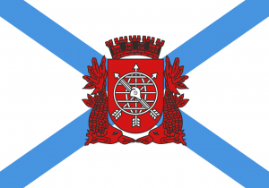 The flag of the city of Rio de Janeiro - a red seal centered on a white background with two crossing blue stripes